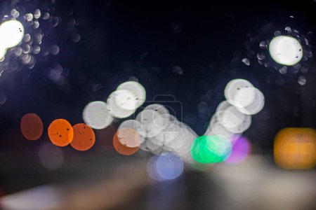 abstract blurred background of multi-colored lights of cars, on the street in the dark
