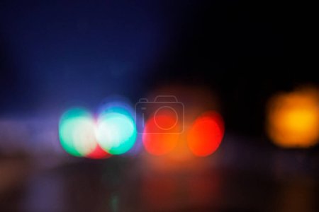 abstract blurred background of multi-colored lights of cars, on the road in the dark