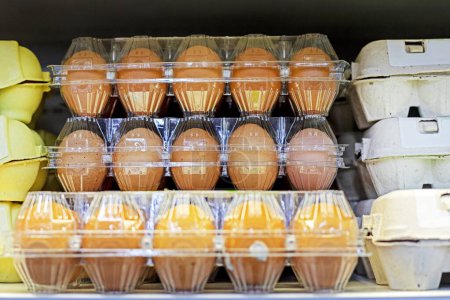 close-up of farm chicken eggs in plastic containers on the store counter
