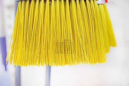close-up of a yellow cleaning brush in a supermarket