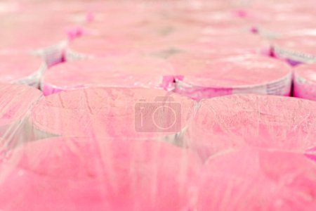 pink toilet paper in transparent plastic packaging