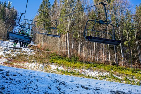 empty ski lift at a ski resort early in the morning illuminated by the sun. family active recreation