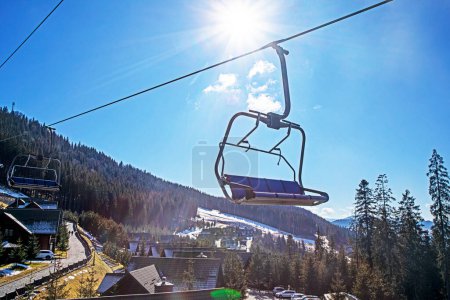 empty ski lift at a ski resort early in the morning illuminated by the rays of the sun. family active recreation
