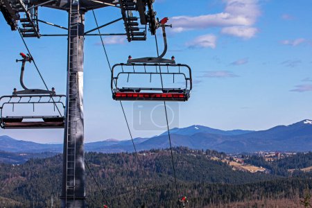 Photo for Ski lift on a sunny day on a snowy slope. Leisure - Royalty Free Image