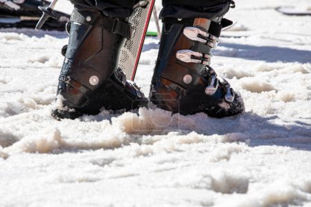 skier walks through the snow in ski boots.Family vacation