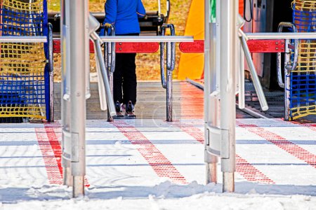 skier stands near the entrance to the ski lift in the morning. Active family vacation