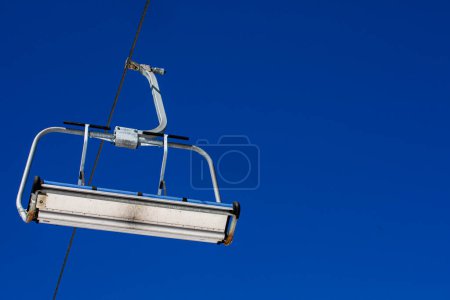 close-up of a ski lift against a background of blue sky with clouds. Ski resort Active recreation