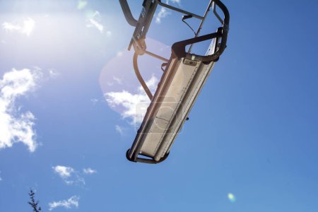 close-up of ski lifts against the background of a blue sky with clouds. Ski resort Active recreation