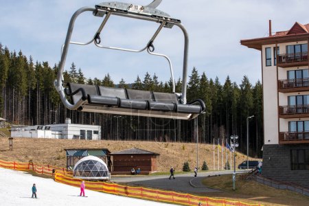 empty chairs on a ski lift on a slope where skiers ski. leisure