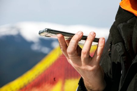 talking on the phone on a snowy slope at a ski resort. Active recreation and doing business