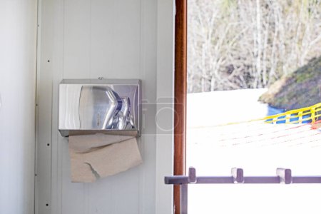 Photo for Paper napkins for hands and face in the toilet room near the window - Royalty Free Image