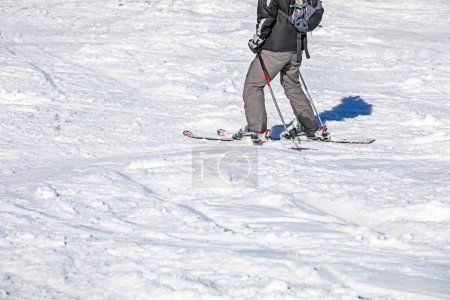 skier descends from a slope on a sunny day. Active recreation. School holidays