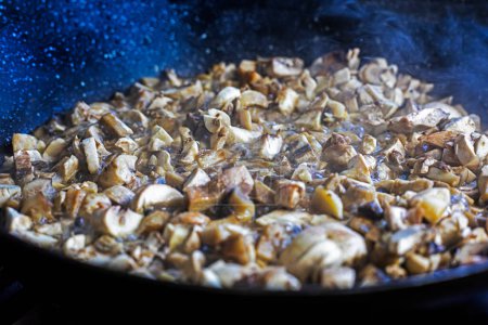 finely chopped champion mushrooms in a frying pan. Vegan edor nutrition. vegetable protein