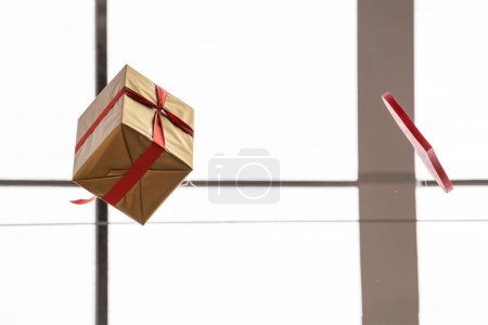 gift wrapped in a box with a red ribbon. holiday