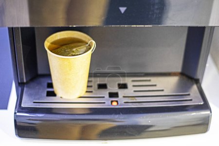 machine with disposable cardboard cup of secondary processing of green tea. Ecology of the environment