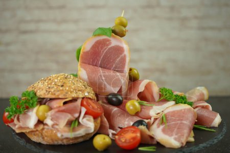 Téléchargez les photos : Iberian smoked ham sandwich with whole grain bun, Spanish meat composition - en image libre de droit