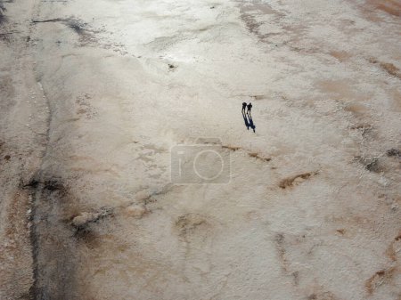 Téléchargez les photos : Vue aérienne du lac Tuz, Tuz Golu. Salt Lake. Eau salée blanche. C'est le deuxième plus grand lac de Turquie. deux hommes debout au milieu du lac salé. Photo de haute qualité - en image libre de droit