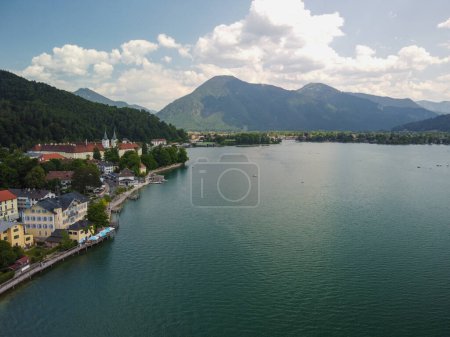 a beautiful view with mountains, a blue sky in the clouds, of a lake in Bavaria,Germany and a church standing on the shore. High quality photo