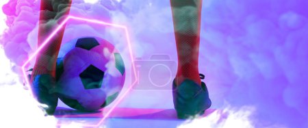 Photo for Low section of male player wearing red socks and black shoes with ball and illuminated hexagon. Copy space, composite, sport, soccer, competition, neon, illustration, glowing, smoke and abstract. - Royalty Free Image