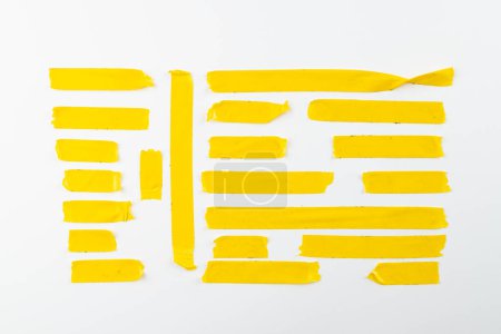 Photo for Ripped up pieces of yellow tape with copy space on white background. Abstract paper texture background and communication concept. - Royalty Free Image