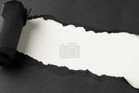 Photo for Ripped up piece of black paper with copy space on white background. Abstract paper texture background and communication concept. - Royalty Free Image