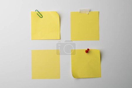 Téléchargez les photos : Notes collantes jaunes avec espace de copie sur fond blanc. Texture abstraite du papier fond et concept de communication. - en image libre de droit