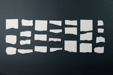 Photo for Ripped up pieces of white paper with copy space on black background. Abstract paper texture background and communication concept. - Royalty Free Image