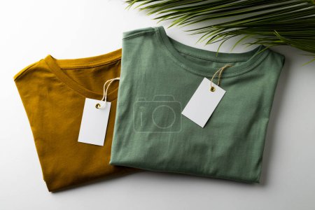 Photo for Close up of tshirts with tags and copy space on white background. Clothing, fashion and retail concept. - Royalty Free Image