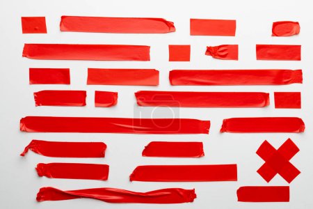 Photo for Ripped up pieces of red tape with copy space on white background. Abstract paper texture background and communication concept. - Royalty Free Image