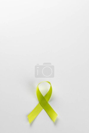 Photo for Vertical composition of light green std health awareness ribbon, on white background with copy space. Medicine, healthcare and health awareness concept. - Royalty Free Image