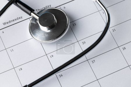 Photo for Close up, full frame composition of stethoscope on calendar. Medical services, healthcare and health awareness concept. - Royalty Free Image