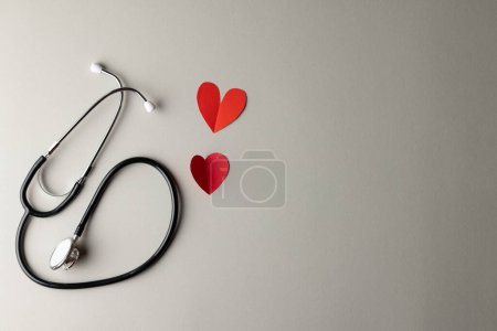Photo for Composition of stethoscope and two red paper hearts on grey background with copy space. Medical services, healthcare and health awareness concept. - Royalty Free Image
