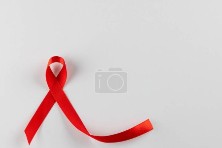 Photo for Composition of red ribbon for hiv or aids awareness, on white background with copy space. Medicine, healthcare and health awareness concept. - Royalty Free Image