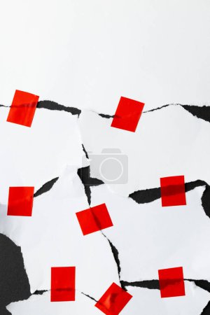 Photo for Ripped up pieces of white paper stuck together with red tape with copy space on black background. Abstract paper texture background and communication concept. - Royalty Free Image