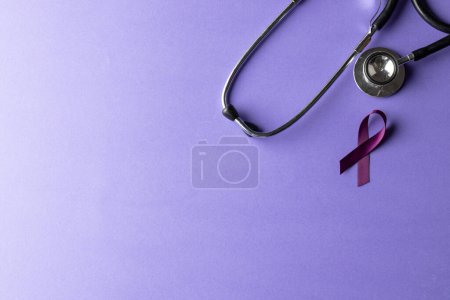 Photo for Stethoscope and purple add or adhd awareness ribbon on purple background with copy space. Medical services, healthcare and mental health awareness concept. - Royalty Free Image