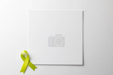 Photo for Composition of light green std health awareness ribbon and central copy space on white background. Medicine, healthcare and health awareness concept. - Royalty Free Image