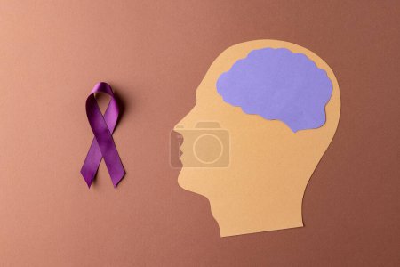 Photo for Purple add or adhd awareness ribbon and head with purple brain on brown background, with copy space. Medical services, healthcare and mental health awareness concept. - Royalty Free Image