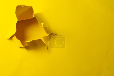 Photo for Ripped up piece of yellow paper with copy space on yellow background. Abstract paper texture background and communication concept. - Royalty Free Image