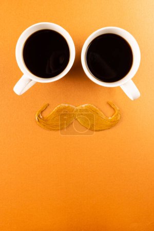 Foto de Composición de bigote falso y tazas de café sobre fondo naranja con espacio para copiar. Día de bigote falso, fiesta, celebración y concepto de vestuario. - Imagen libre de derechos