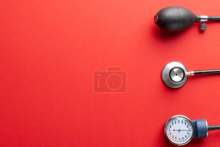 Photo for Composition of sphygmomanometer and stethoscope on red background with copy space. Medical services, healthcare and health awareness concept. - Royalty Free Image