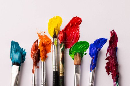 Composition of painting brushes on white background with copy space. National craft month, painting, art and creativity concept.