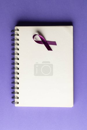 Photo for Vertical of purple add or adhd awareness ribbon on notebook with copy space, on purple background. Medical services, healthcare and mental health awareness concept. - Royalty Free Image