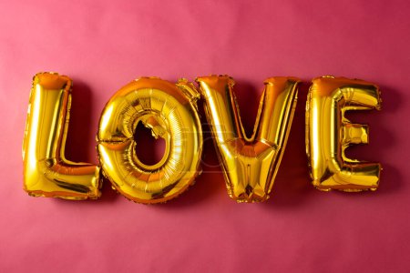 Photo for Metallic gold love text balloon on pink background with copy space. Valentine's day, love, romance and celebration concept. - Royalty Free Image