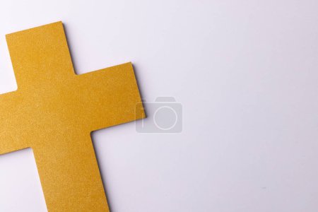 Photo for Overhead of yellow christian cross, on white background with copy space. Christianity, faith, celebration and religion concept. - Royalty Free Image