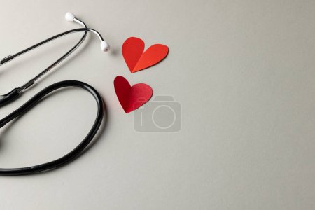 Photo for Composition of stethoscope and two red paper hearts on grey background with copy space. Medical services, healthcare and health awareness concept. - Royalty Free Image