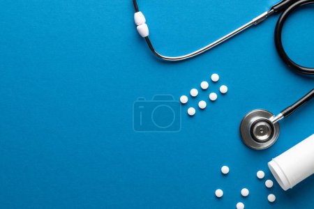 Photo for Composition of stethoscope with pills on blue background with copy space. Medical services, healthcare and health awareness concept. - Royalty Free Image