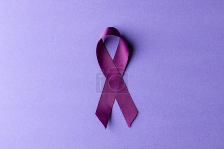Photo for Composition of purple add or adhd awareness ribbon on purple background, with copy space. Medical services, healthcare and mental health awareness concept. - Royalty Free Image