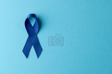 Photo for Composition of blue ribbon for prostate cancer awareness, on blue background with copy space. Medicine, healthcare and health awareness concept. - Royalty Free Image