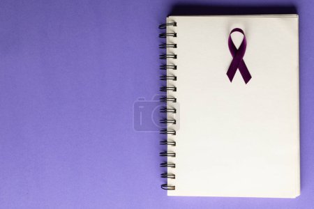 Photo for Composition of purple add or adhd awareness ribbon and notebook on purple background with copy space. Medical services, healthcare and health awareness concept. - Royalty Free Image