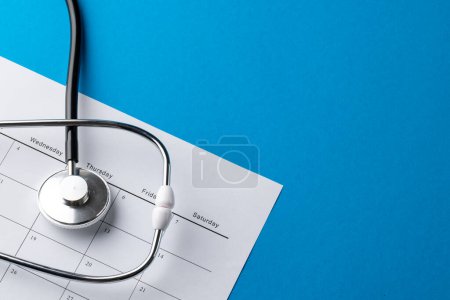 Photo for Composition of stethoscope with calendar on blue background with copy space. Medical services, healthcare and health awareness concept. - Royalty Free Image